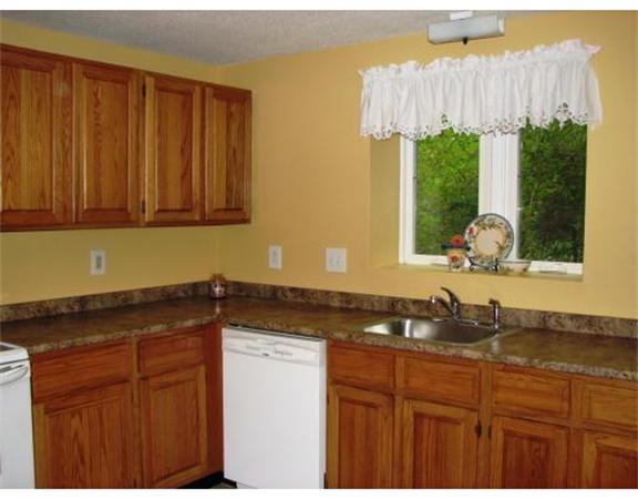 35 Cedar Street, Unit 2 Gardner, MA 01440 - Photo 3 of 9 a bathroom with a granite countertop sink and a bathtub