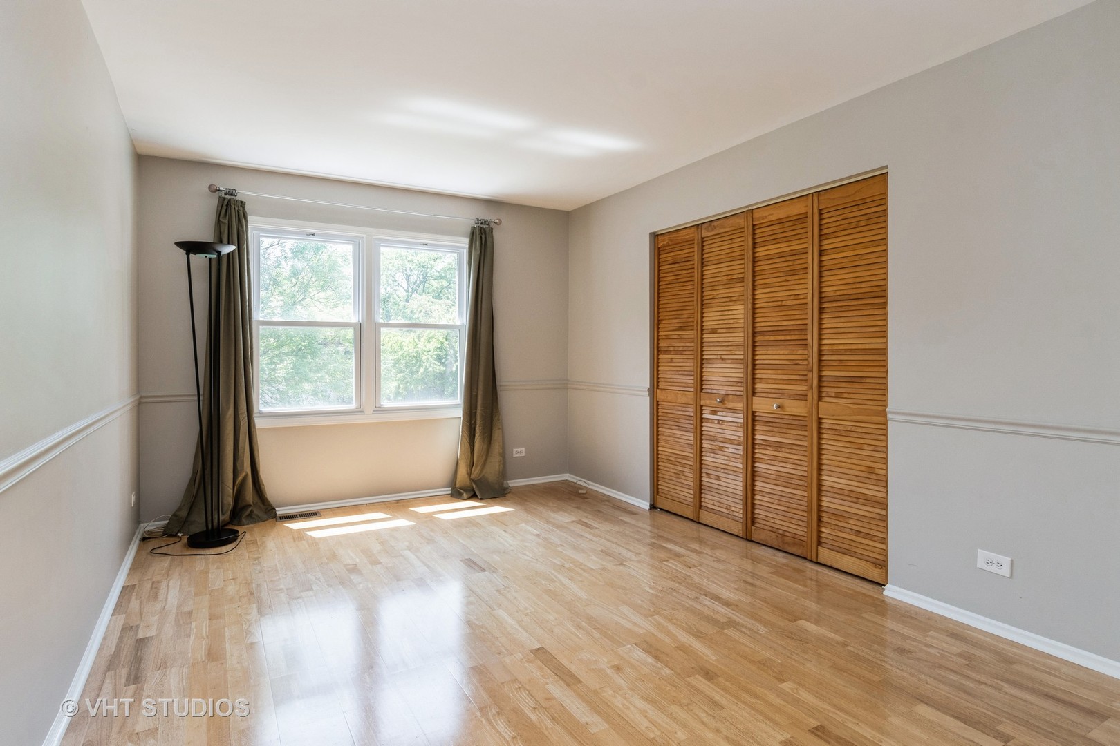 2272 Pontiac Circle Naperville, IL 60565 - Photo 9 of 14 a view of an empty room with wooden floor and a window