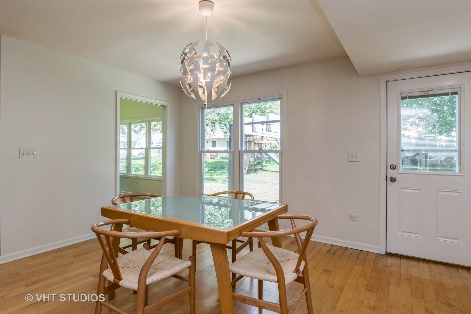 2272 Pontiac Circle Naperville, IL 60565 - Photo 2 of 14 a view of a dining room with furniture a chandelier and wooden floor