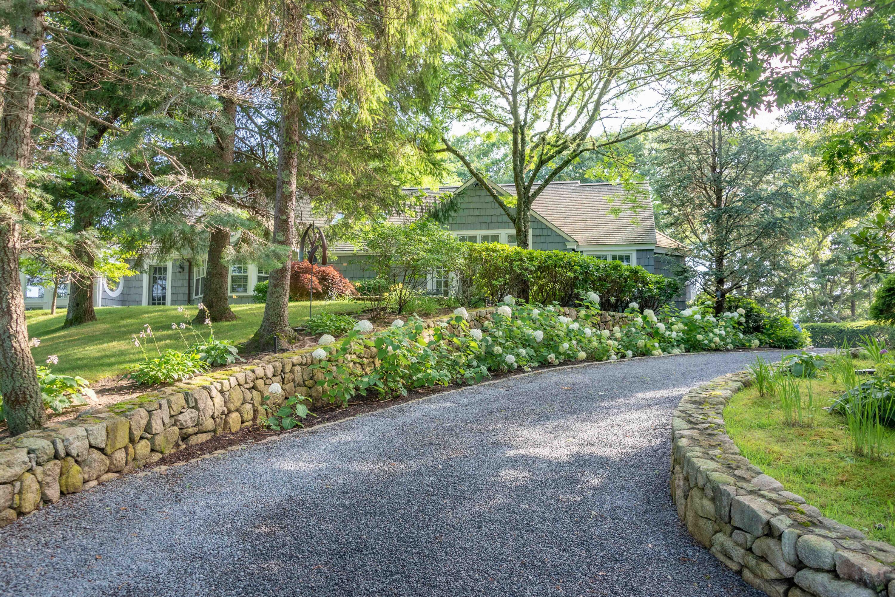 68 Waterman Farm Road Centerville, MA 02632 - Photo 5 of 47 a view of a garden with a bench