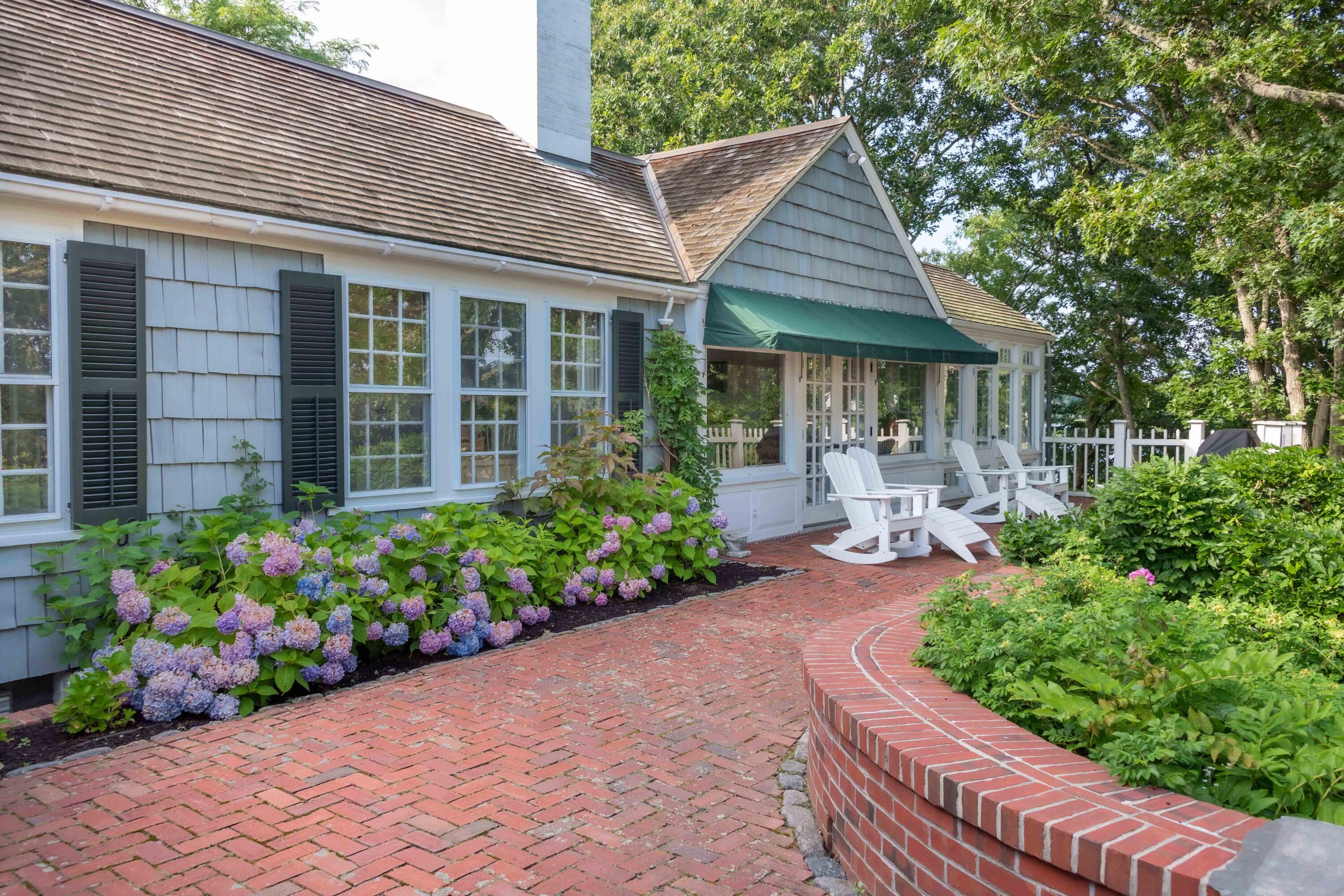 68 Waterman Farm Road Centerville, MA 02632 - Photo 9 of 47 a front view of a house with a yard and plants