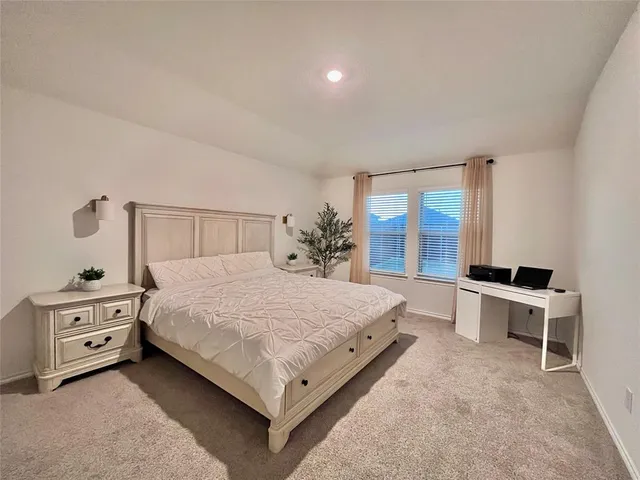 a bedroom with a bed and a desk