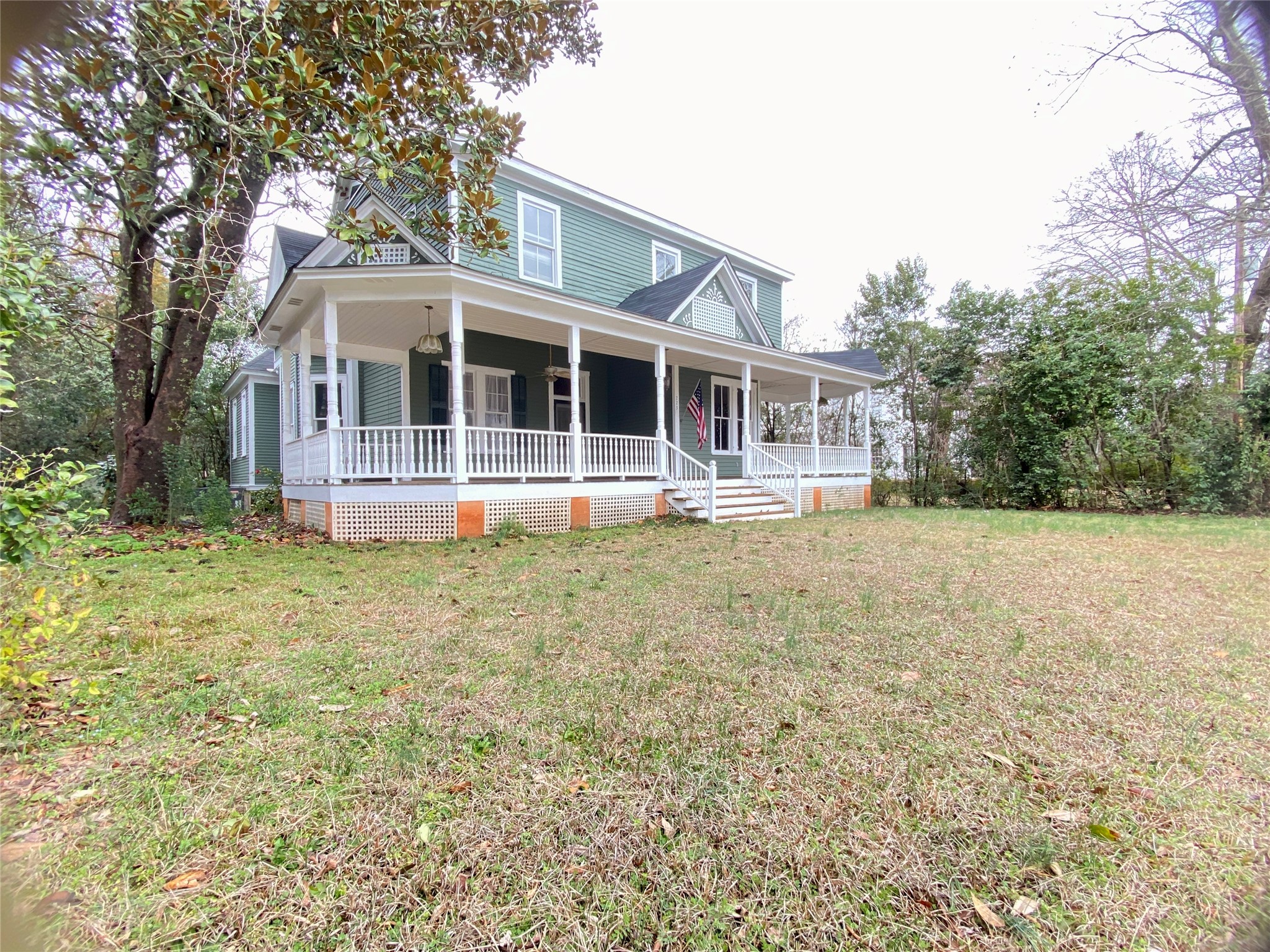 223 East Robert Toombs Avenue Washington, GA 30673 - Photo 2 of 46 a front view of a house with a yard and trees