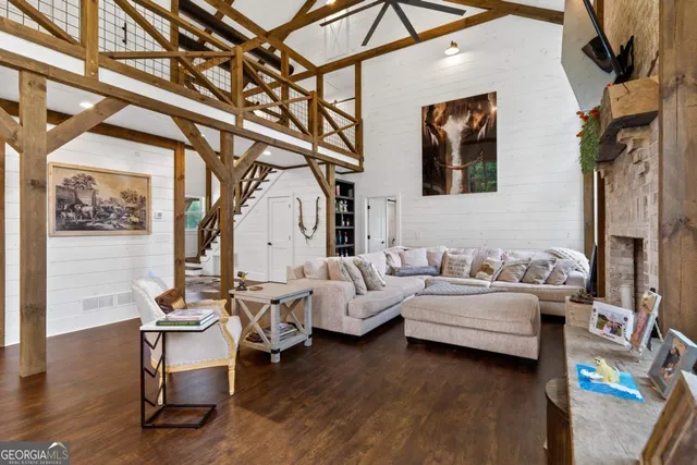 a view of a dining room with furniture a chandelier and wooden floor