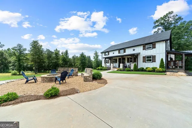 a view of a house with sitting area and garden