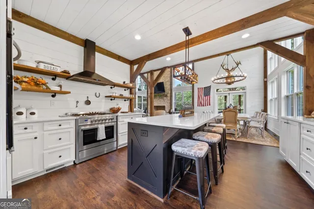 a view of a living room with a tub and wooden floor