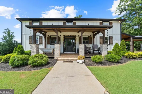 a view of a house with many windows and plants