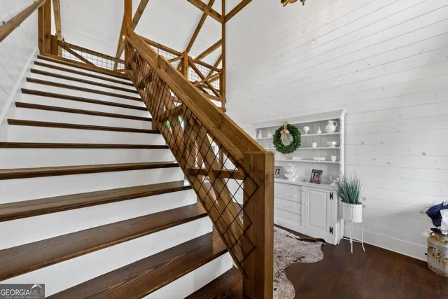 a view of a livingroom with wooden floor and a ceiling fan