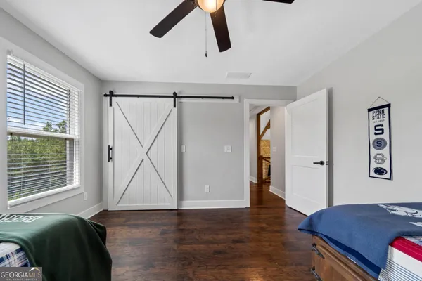 a living room with furniture a fireplace a flat screen tv and windows