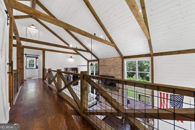 a living room with fireplace furniture and large windows