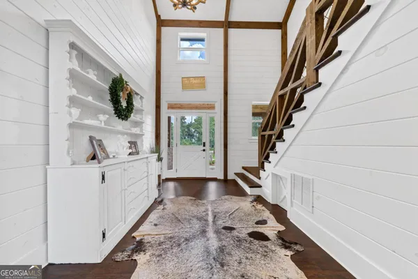 a living room with couches fireplace and a flat screen tv