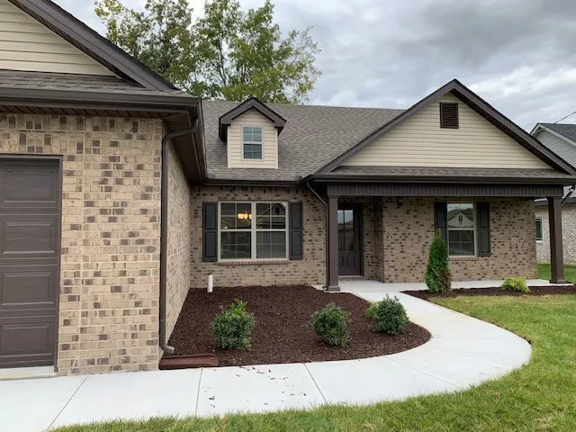a front view of a house with garden and porch