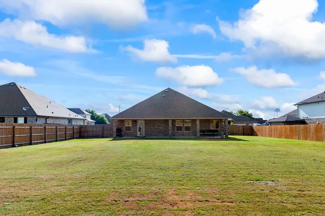 a front view of a house with outdoor seating and plants