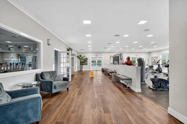 a living room with furniture gym equipment and a window