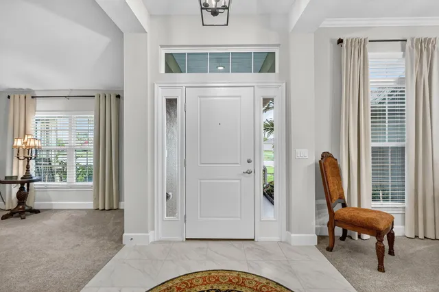 a living room with furniture ceiling fan and a flat screen tv