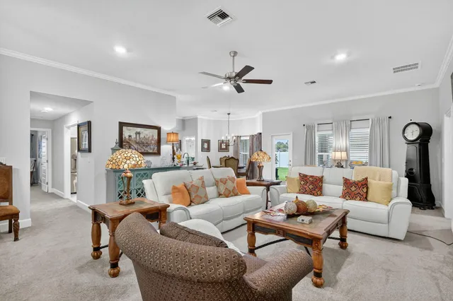 a view of a dining room with furniture and a window