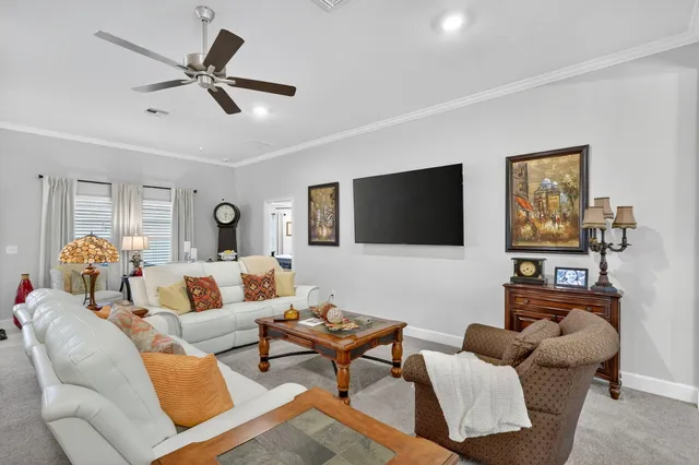 a kitchen with stainless steel appliances granite countertop a stove top oven a sink dishwasher a refrigerator and white cabinets with wooden floor