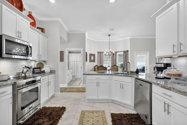 a en suite bathroom with a granite countertop sink a mirror and a shower