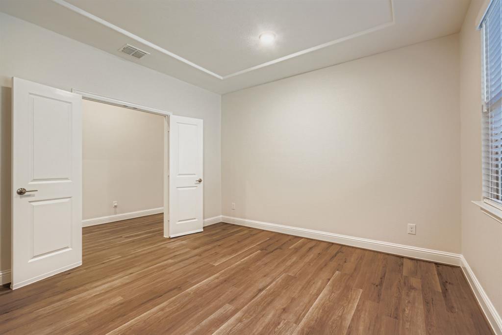 312 Magnolia Drive Oak Point, TX 75068 - Photo 7 of 28 Unfurnished bedroom with baseboards and wood finished floors