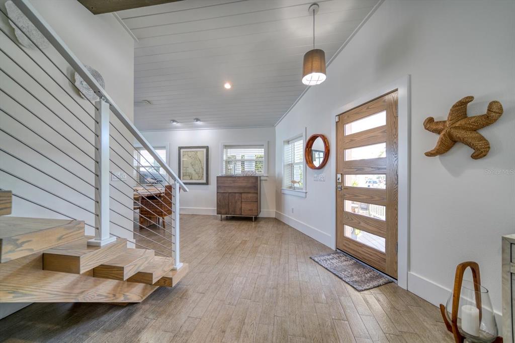 478 20th Avenue Indian Rocks Beach, FL 33785 - Photo 9 of 80 Vaulted foyer and one of two staircases to seconnd floor