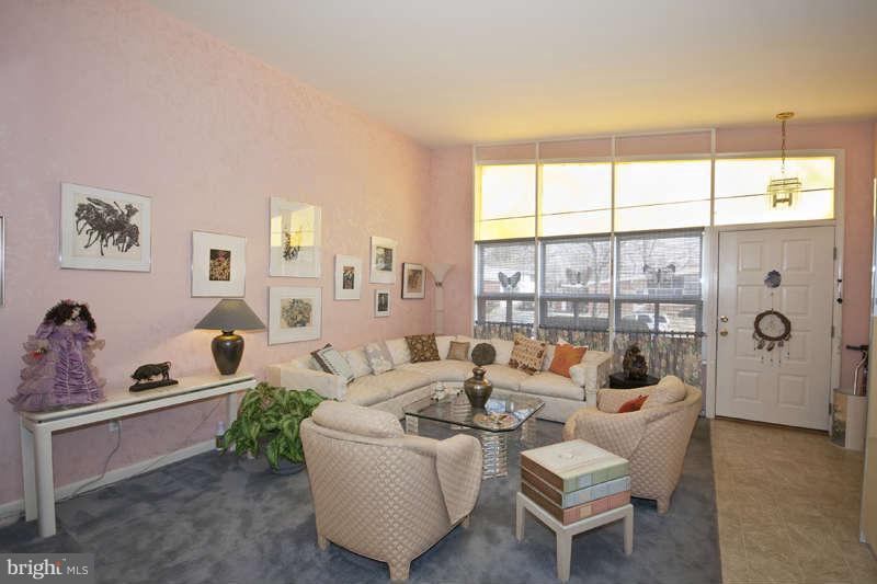 8119 Scotts Level Road Baltimore, MD 21208 - Photo 2 of 24 a living room with furniture and a large window
