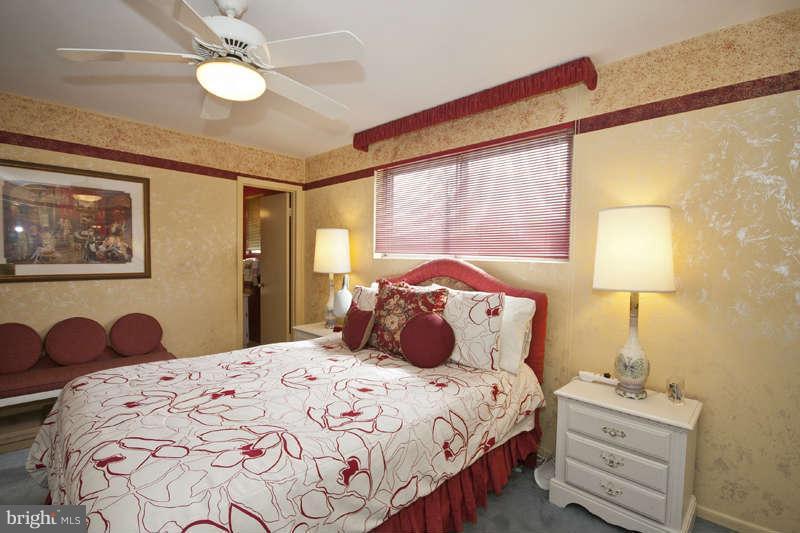 8119 Scotts Level Road Baltimore, MD 21208 - Photo 11 of 24 a bedroom with a bed and a chandelier
