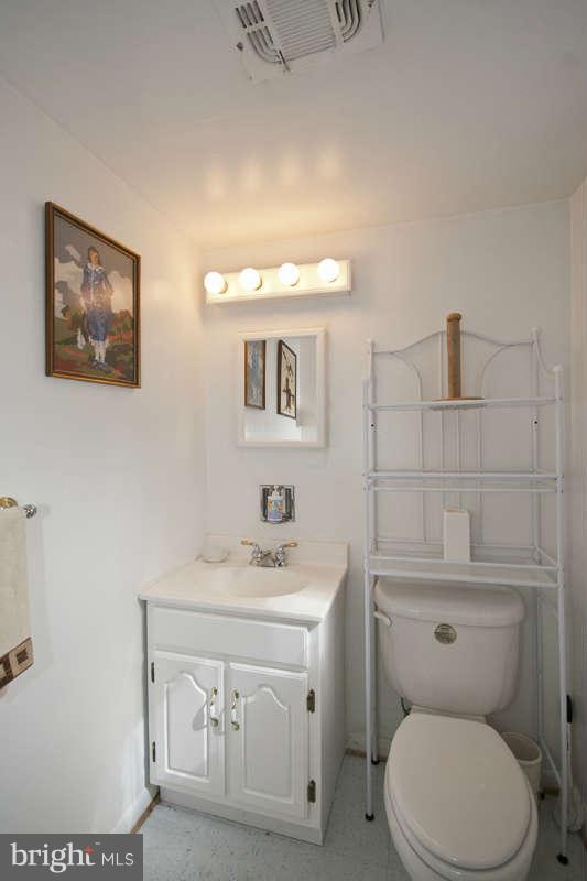 8119 Scotts Level Road Baltimore, MD 21208 - Photo 12 of 24 a bathroom with a sink toilet and vanity