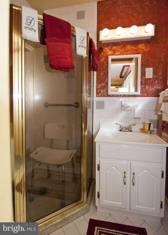 8119 Scotts Level Road Baltimore, MD 21208 - Photo 13 of 24 a bathroom with a sink and a mirror