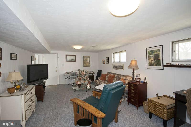 8119 Scotts Level Road Baltimore, MD 21208 - Photo 17 of 24 a living room with furniture a flat screen tv and a window