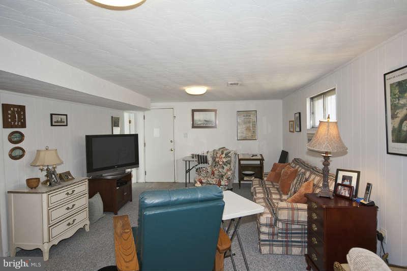 8119 Scotts Level Road Baltimore, MD 21208 - Photo 18 of 24 a living room with furniture a flat screen tv and dresser