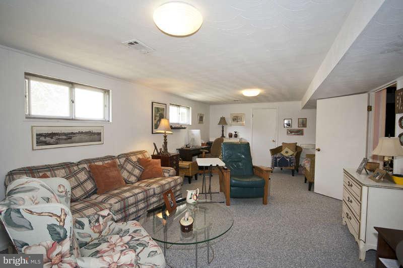 8119 Scotts Level Road Baltimore, MD 21208 - Photo 19 of 24 a living room with furniture a couch and a flat screen tv
