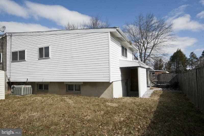 8119 Scotts Level Road Baltimore, MD 21208 - Photo 24 of 24 a view of a house with a backyard and wooden roof