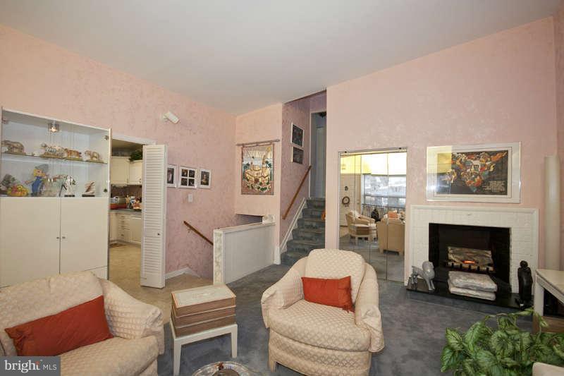 8119 Scotts Level Road Baltimore, MD 21208 - Photo 4 of 24 a living room with furniture and a fireplace