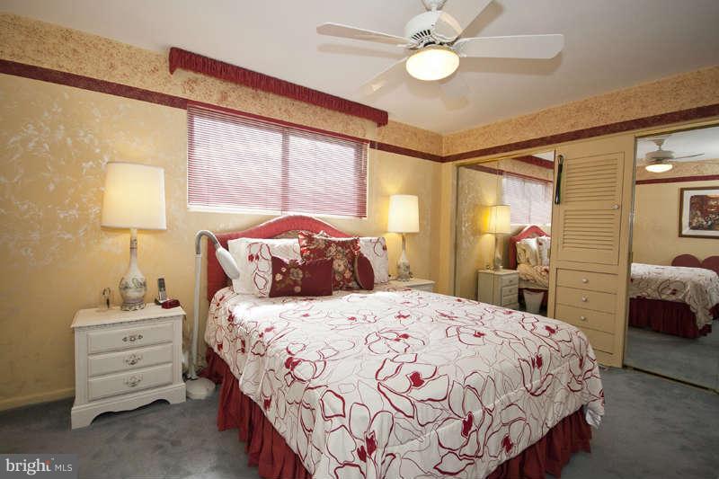 8119 Scotts Level Road Baltimore, MD 21208 - Photo 10 of 24 a bedroom with a bed and a chandelier