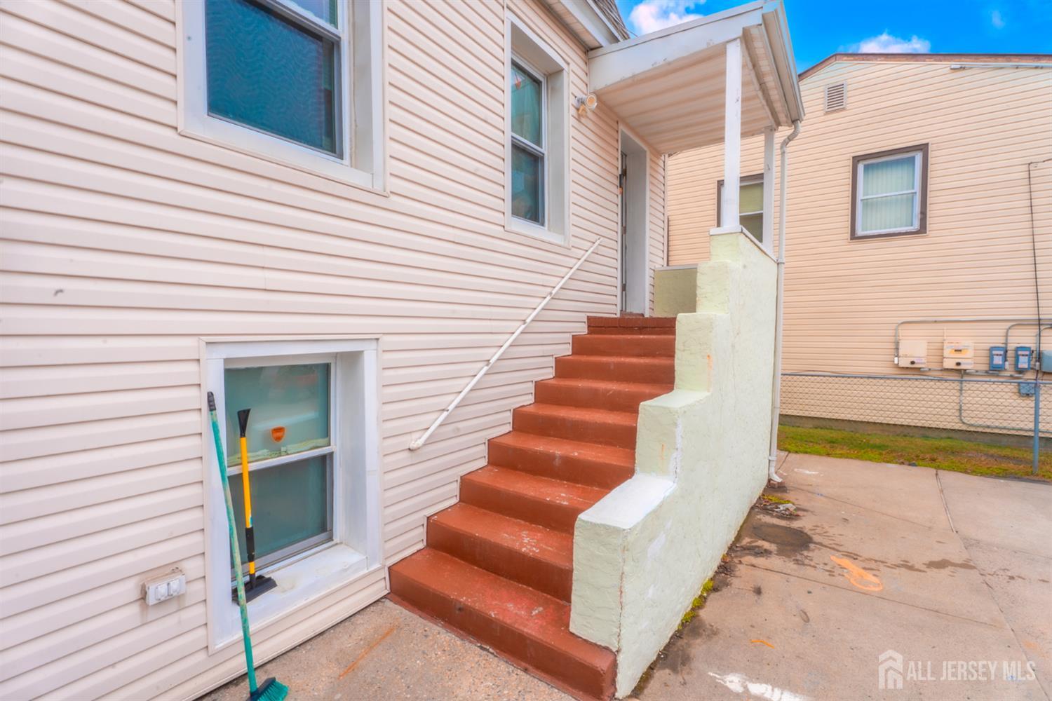 439 Ashley Street Perth Amboy, NJ 08861 - Photo 15 of 17 a view of a house with wooden floor and a large tree