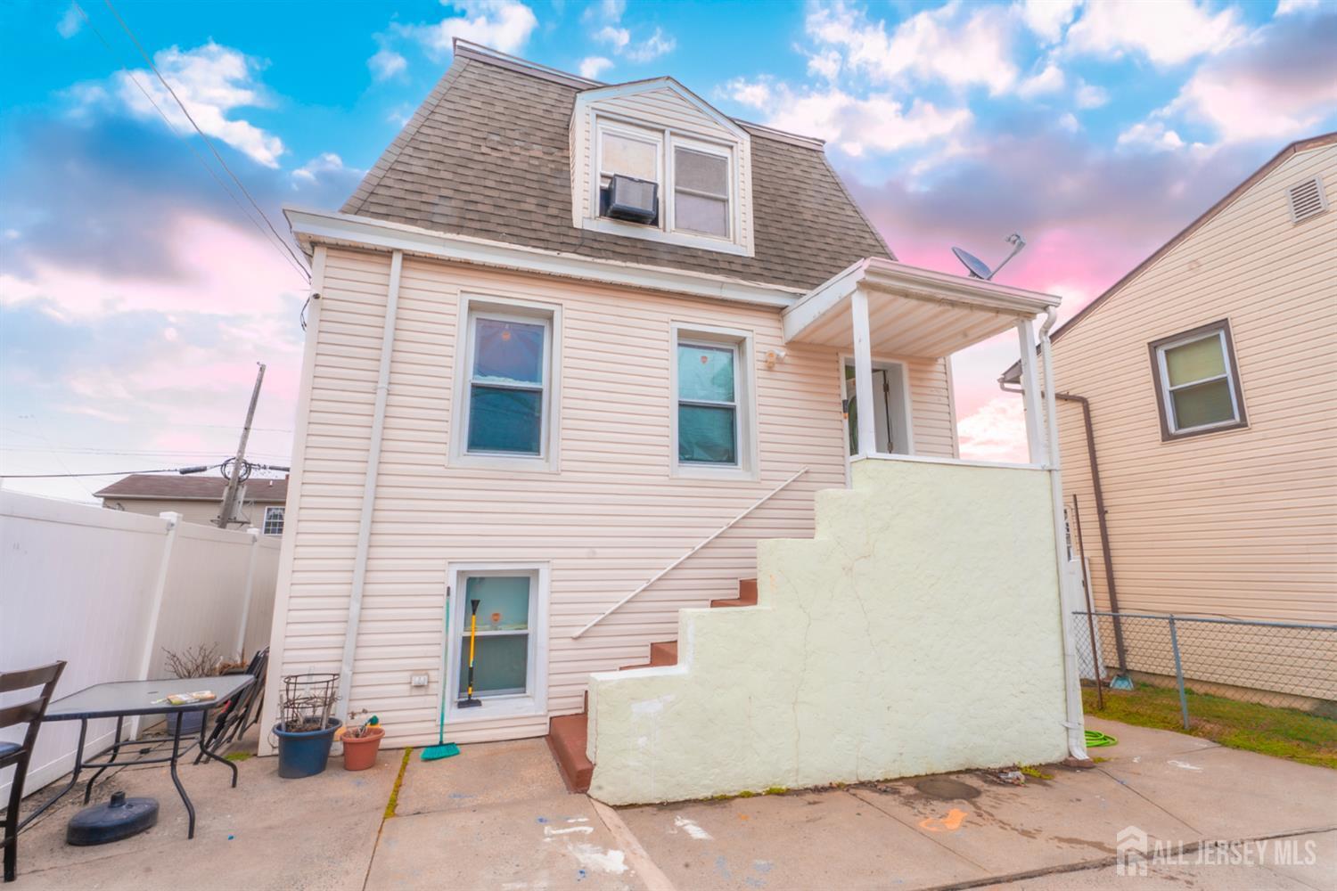 439 Ashley Street Perth Amboy, NJ 08861 - Photo 16 of 17 a view of a brick house with many windows