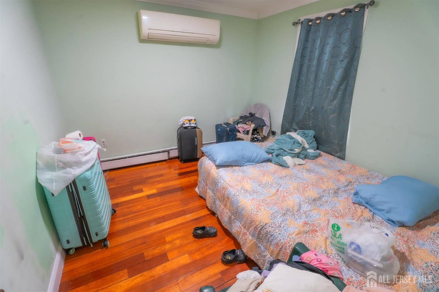 439 Ashley Street Perth Amboy, NJ 08861 - Photo 8 of 17 a bedroom with a bed and wooden floor