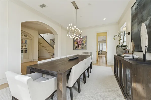 a view of a dining room with furniture and a chandelier