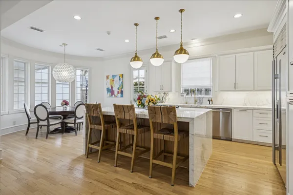 a large kitchen with a table and chairs