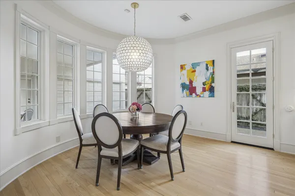 a view of a dining room with furniture wooden floor and chandelier