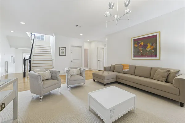 a living room with furniture and a chandelier