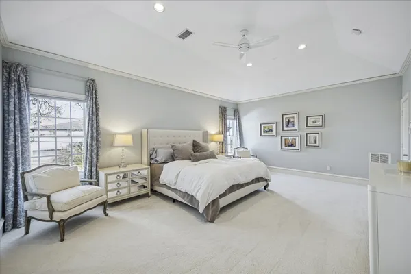 a spacious bedroom with a bed and a couch