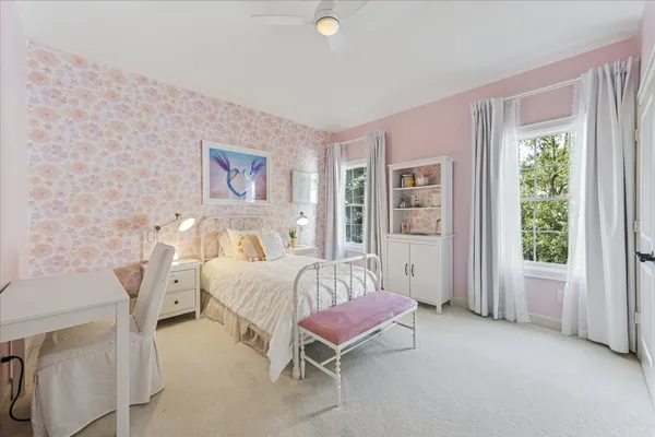 a spacious bedroom with a bed and a window