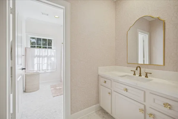 a bathroom with a double vanity sink mirror and