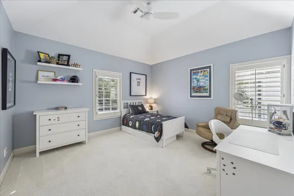 a bedroom with furniture and a window