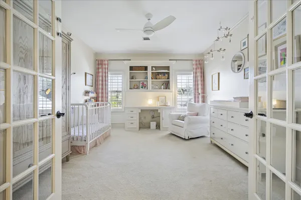 a spacious bedroom with a bed and ceiling fan
