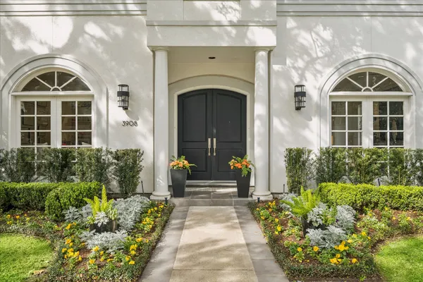 a front view of a house with a garden