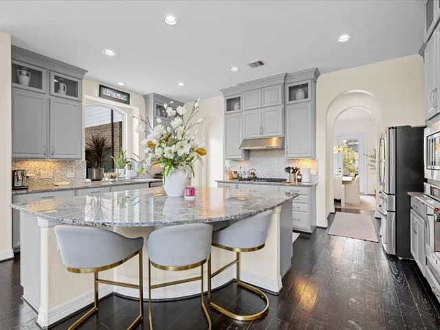 a kitchen with stainless steel appliances white cabinets and a sink