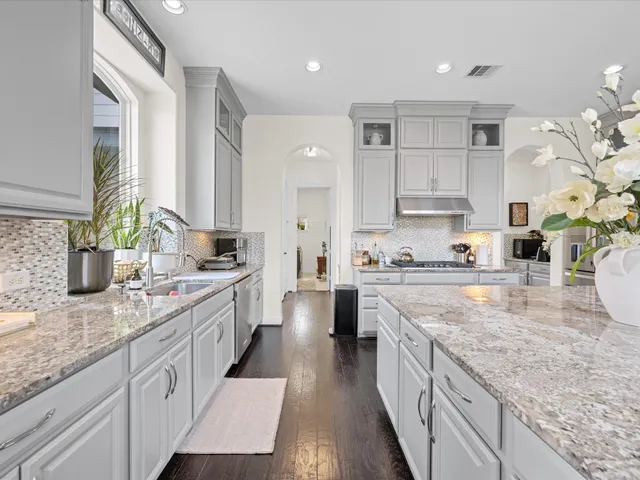 a spacious bedroom with a bed and a potted plant