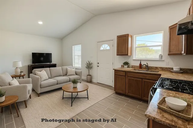 a living room with furniture a rug a window and a fireplace